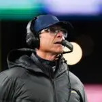 Los Angeles Chargers head coach Jim Harbaugh looks on during the first quarter against the New England Patriots in an AFC Wild Card Round game at Gillette Stadium on Jan 11, 2026.