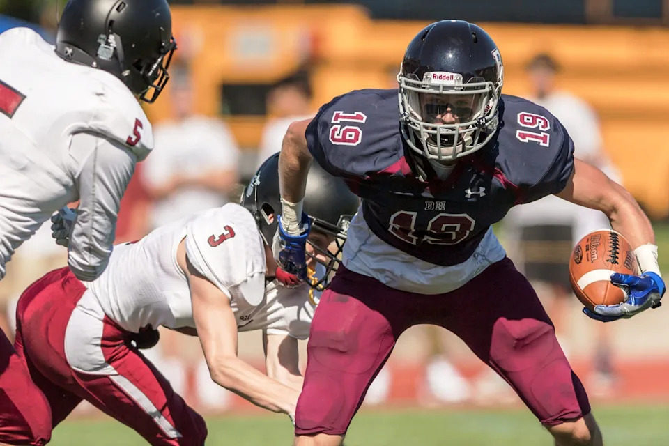 Jake Bobo of Concord looks to avoid a tackle while playing for Belmont Hill in a game this past fall. [Courtesy photo Belmont Hill School/Adam Richins.]