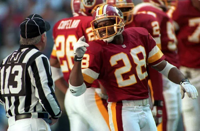 Washington Redskins cornerback Darrel Green (28) argues with field judge Don Dorkowski (113) after Green was called for pass interferance during first quarter action 26 December 1993 in Irving, TX. The penalty set up Dallas' first touchdown. (Photo by TIM ROBERTS / AFP) (Photo credit should read TIM ROBERTS/AFP via Getty Images)