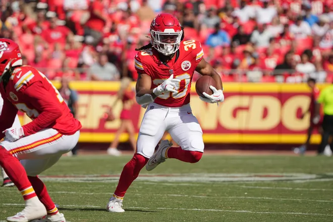 Aug 17, 2024; Kansas City, Missouri, USA; Kansas City Chiefs running back Keaontay Ingram (30) runs the ball against the Detroit Lions during the first half at GEHA Field at Arrowhead Stadium. Mandatory Credit: Denny Medley-USA TODAY Sports