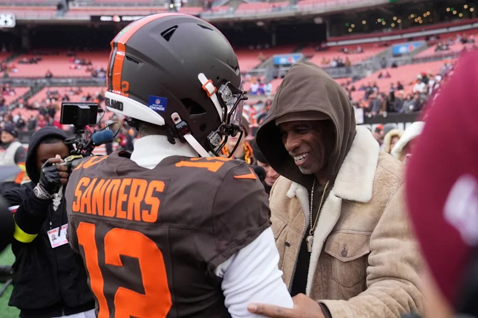 Cleveland Browns quarterback Shedeur Sanders (12) visits with his father Deion Sanders, right, during warmups before an NFL football game against the Tennessee Titans in Cleveland, Sunday, Dec. 7, 2025. AP