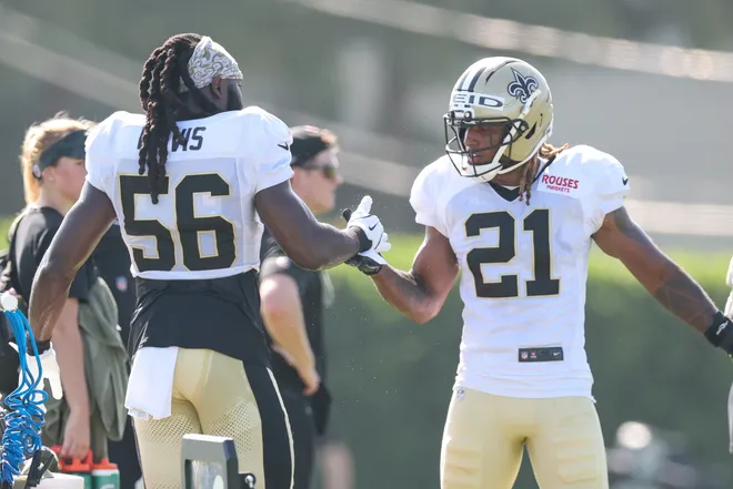 Jul 28, 2025; Metairie, LA, USA; New Orleans Saints linebacker Demario Davis (56) and safety Justin Reid (21) shake hands during training camp at Ochsner Sports Performance Center. Mandatory Credit: Stephen Lew-Imagn Images