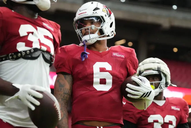 Arizona Cardinals running backs James Conner (6) and Trey Benson (33) work out during the team's practice at State Farm Stadium on July 29, 2025.