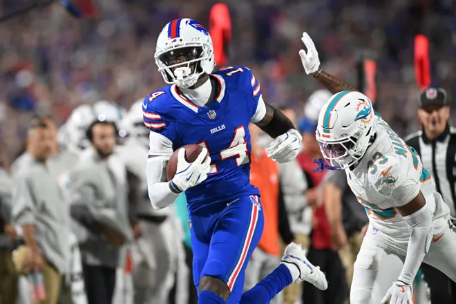 Sep 18, 2025; Orchard Park, New York, USA; Buffalo Bills wide receiver Tyrell Shavers (14) runs the ball against Miami Dolphins cornerback Jason Marshall Jr. (33) in the first half at Highmark Stadium. Mandatory Credit: Mark Konezny-Imagn Images