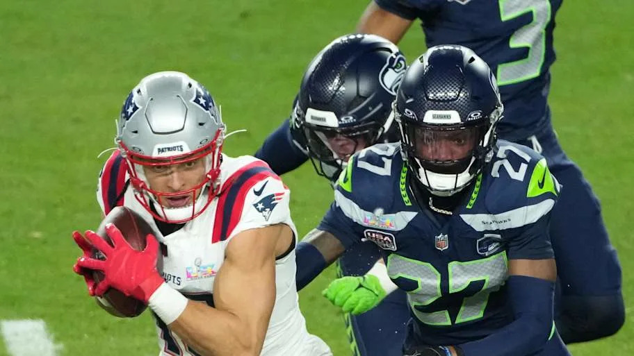 New England Patriots wide receiver Mack Hollins catches a pass against Seattle Seahawks cornerback Riq Woolen