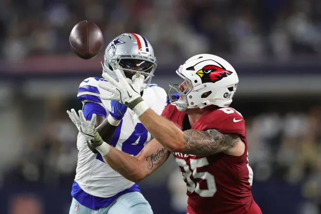 ARLINGTON, TEXAS - NOVEMBER 03: Trey McBride #85 of the Arizona Cardinals successfully defended by Markquese Bell #14 of the Dallas Cowboys during the first quarter in the game at AT&T Stadium on November 03, 2025 in Arlington, Texas. (Photo by Stacy Revere/Getty Images)