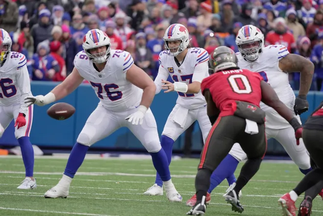 Tampa Bay Buccaneers linebacker Yaya Diaby heads towards Buffalo Bills quarterback Josh Allen who was just getting the snap during first half action against the Tampa Bay Buccaneers on Nov 16, 2025 at Highmark Stadium in Orchard Park. Guarding Allen are Buffalo Bills guard David Edwards and offensive tackle Dion Dawkins.