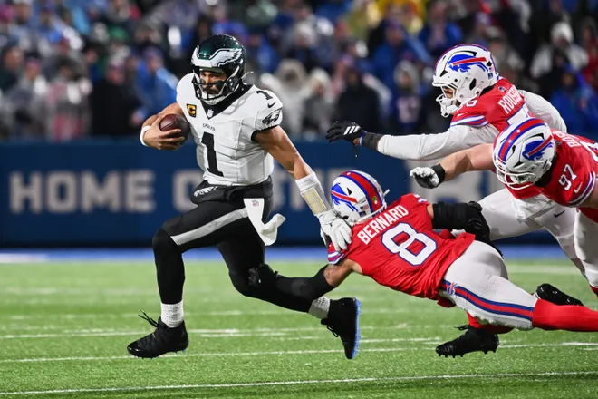 Dec 28, 2025; Orchard Park, New York, USA; Philadelphia Eagles quarterback Jalen Hurts (1) runs the ball against Buffalo Bills linebacker Terrel Bernard (8), defensive end Greg Rousseau (50) and defensive end Joey Bosa (97) during the second quarter at Highmark Stadium. Mandatory Credit: Mark Konezny-Imagn Images