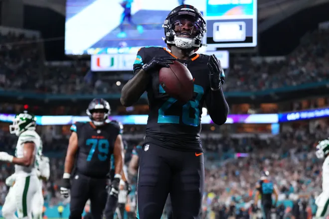 Sep 29, 2025; Miami Gardens, Florida, USA; Miami Dolphins running back De'von Achane (28) reacts after rushing for a touchdown against the New York Jets during the second half at Hard Rock Stadium. Mandatory Credit: Rich Storry-Imagn Images