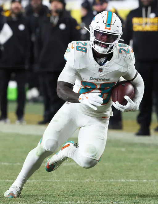 Dec 15, 2025; Pittsburgh, Pennsylvania, USA; Miami Dolphins running back De'Von Achane (28) moves with the ball in the fourth quarter against the Pittsburgh Steelers at Acrisure Stadium. Mandatory Credit: Charles LeClaire-Imagn Images