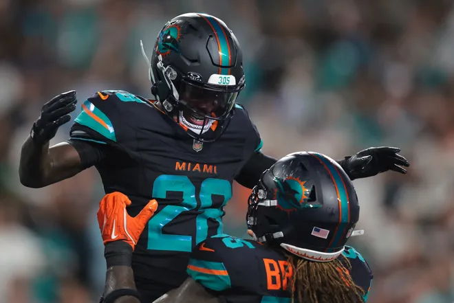 Sep 29, 2025; Miami Gardens, Florida, USA; Miami Dolphins running back De'von Achane (28) reacts after scoring a touchdown against the New York Jets during the second half at Hard Rock Stadium. Mandatory Credit: Sam Navarro-Imagn Images