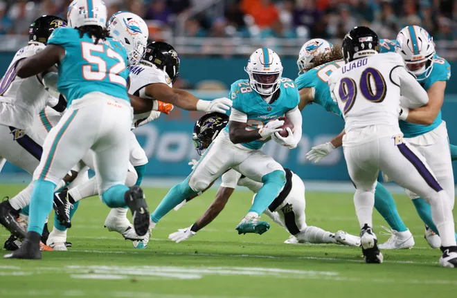 Oct 30, 2025; Miami Gardens, Florida, USA; Miami Dolphins running back De'Von Achane (28) runs for a gain during the first quarter against the Baltimore Ravens at Hard Rock Stadium. Mandatory Credit: Nathan Ray Seebeck-Imagn Images