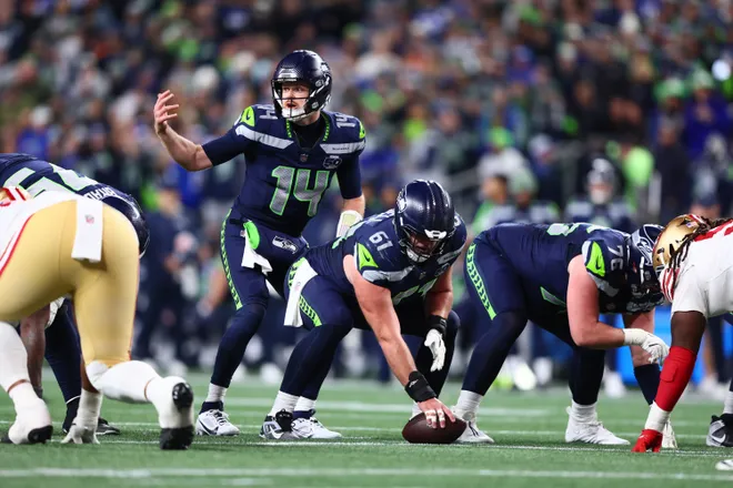 Jan 17, 2026; Seattle, WA, USA; Seattle Seahawks quarterback Sam Darnold (14) under center against the San Francisco 49ers during the second half in an NFC Divisional Round game at Lumen Field. Mandatory Credit: Kevin Ng-Imagn Images