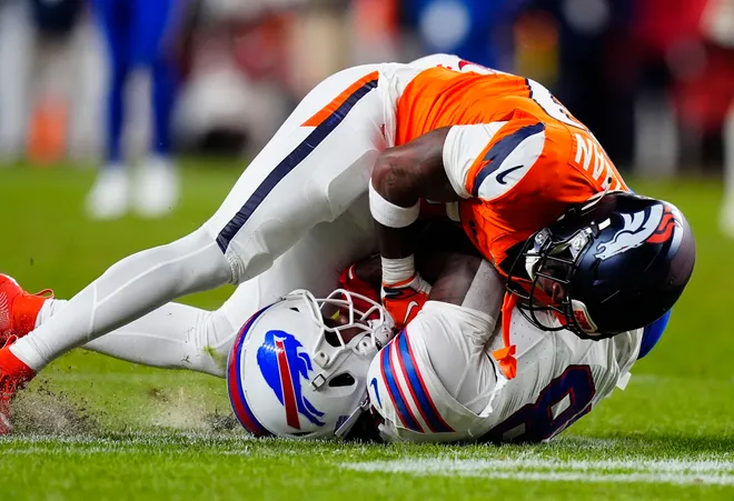 Jan 17, 2026; Denver, CO, USA; Denver Broncos cornerback Ja'quan McMillian (29) intercepts a pass intended for Buffalo Bills wide receiver Brandin Cooks (18) during overtime of an AFC Divisional Round playoff game at Empower Field at Mile High. Mandatory Credit: Ron Chenoy-Imagn Images