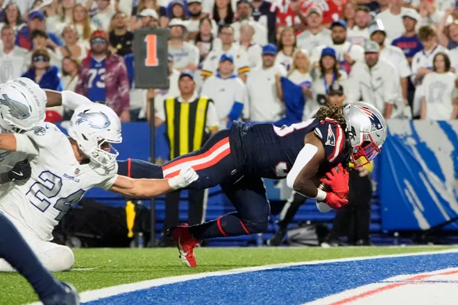 New England Patriots running back Rhamondre Stevenson rushes for a touchdown against the Buffalo Bills during the second half at Highmark Stadium.
