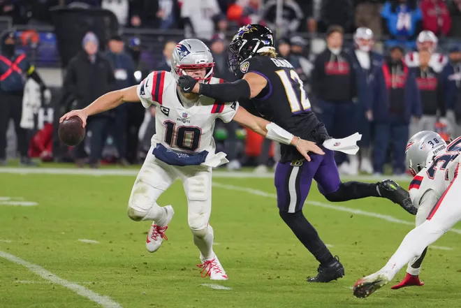 New England Patriots quarterback Drake Maye scrambles against Baltimore Ravens safety Alohi Gilman during the second half.