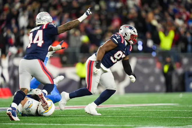 New England Patriots defensive end Milton Williams (97) and linebacker K'lavon Chaisson (44) celebrate a sack during the fourth quarter against the Los Angeles Chargers.