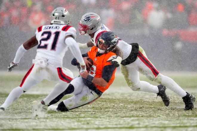 Denver Broncos quarterback Jarrett Stidham rushes against the New England Patriots during the second half.