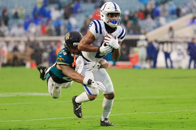 Indianapolis Colts wide receiver Josh Downs (2) is tackled by Jacksonville Jaguars defensive back Cam'Ron Silmon-Craig (24) during the fourth quarter of an NFL football game at EverBank Stadium, Sunday, Dec. 7, 2025, in Jacksonville, Fla. The Jaguars defeated the Colts 36-19. [Corey Perrine/Florida Times-Union]