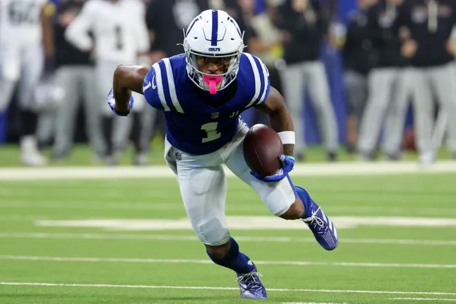 Oct 5, 2025; Indianapolis, Indiana, USA; Indianapolis Colts wide receiver Josh Downs (1) runs with the ball against the Las Vegas Raiders during the second half at Lucas Oil Stadium. Mandatory Credit: Trevor Ruszkowski-Imagn Images