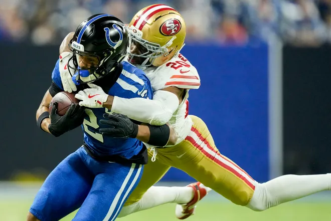 Dec 22, 2025; Indianapolis, Indiana, USA; San Francisco 49ers cornerback Upton Stout (20) tackles Indianapolis Colts wide receiver Josh Downs (2) out of bounds during the second quarter at Lucas Oil Stadium. Mandatory Credit: Grace Hollars-USA TODAY Network via Imagn Images