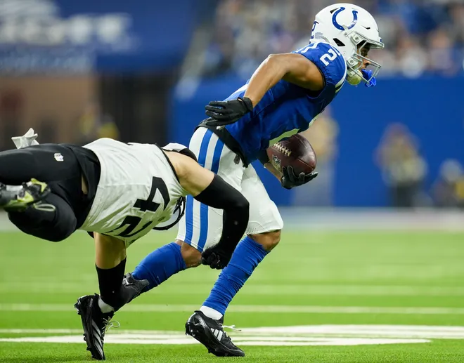 Indianapolis Colts wide receiver Josh Downs (2) slips a tackle by Jacksonville Jaguars safety Andrew Wingard (42) on Sunday, Dec. 28, 2025, during a game against the Jacksonville Jaguars at Lucas Oil Stadium in Indianapolis.