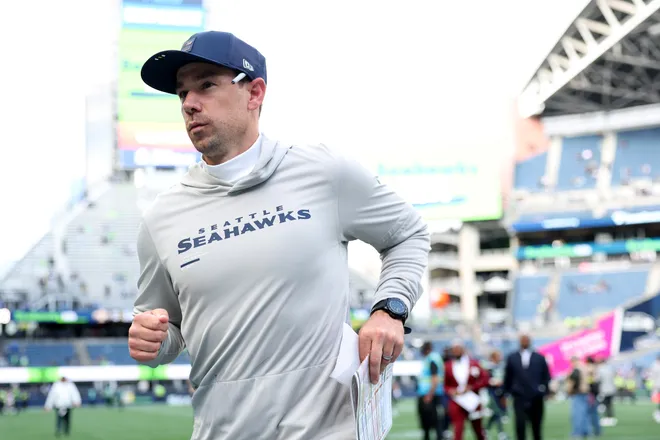 Offensive coordinator Klint Kubiak of the Seattle Seahawks jogs off the field after beating the New Orleans Saints.