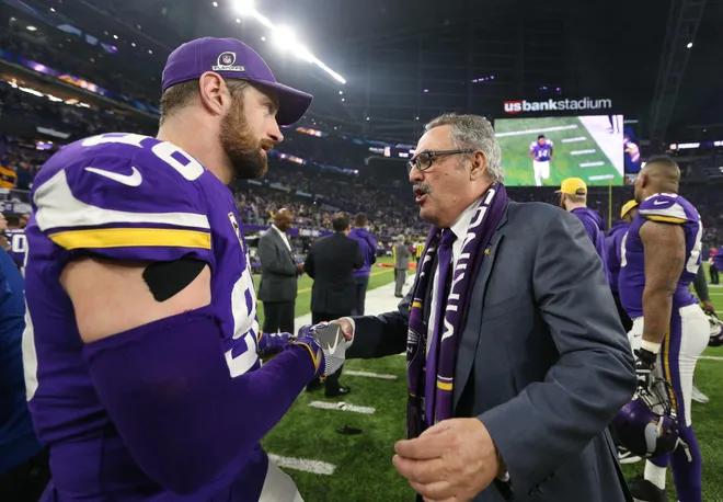 Minnesota Vikings owner Ziggy Wilf greets his players.