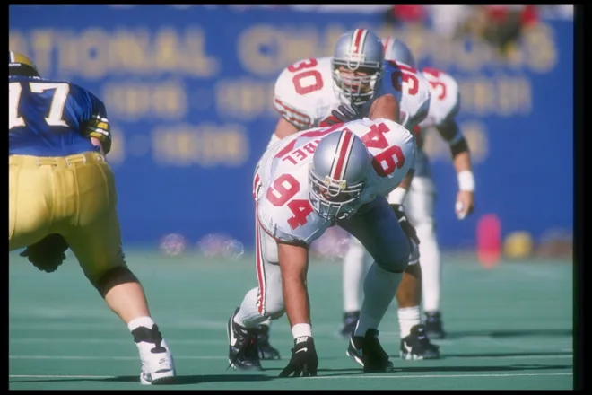 Mike Vrabel of the Ohio State Buckeyes holds the line against the Pittsburgh Panthers.