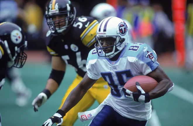 Derrick Mason of the Tennesee Titans moves with the ball against Mike Vrabel of the Pittsburgh Steelers.
