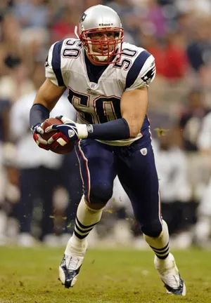 Linebacker Mike Vrabel of the New England Patriots intercepts a pass in overtime against the Houston Texans at Reliant Stadium on November 23, 2003.