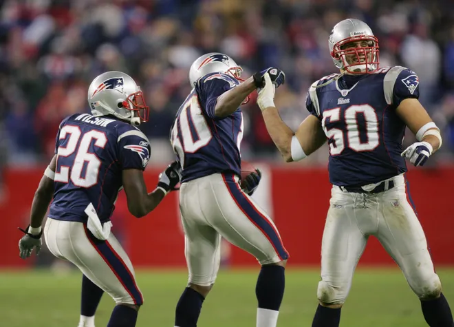 Strong safety Je'Rod Cherry #30 of the New England Patriots celebrates with his teammates cornerback Eugene Wilson #26 and linebacker Mike Vrabel #50.