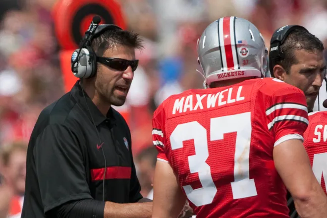 Ohio State Buckeyes linebackers coach Mike Vrabel instructs defensive back Chris Maxwell against the Akron Zips.