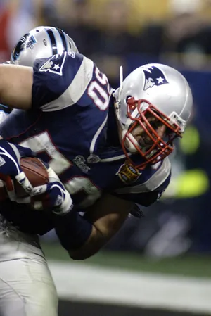 New England Patriots linebacker Mike Vrabel (50) catches a touchdown pass against the Carolina Panthers.