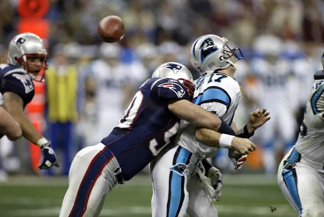 New England Patriots linebacker Mike Vrabel hits Carolina Panthers quarterback Jake Delhomme (17) causing a fumble in the 2nd quarter of Super Bowl XXXVIII.