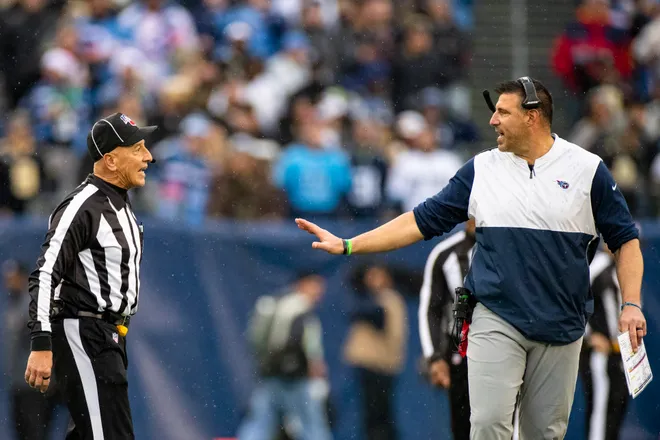 Head coach Mike Vrabel of the Tennessee Titans discusses a fumble call with a referee.