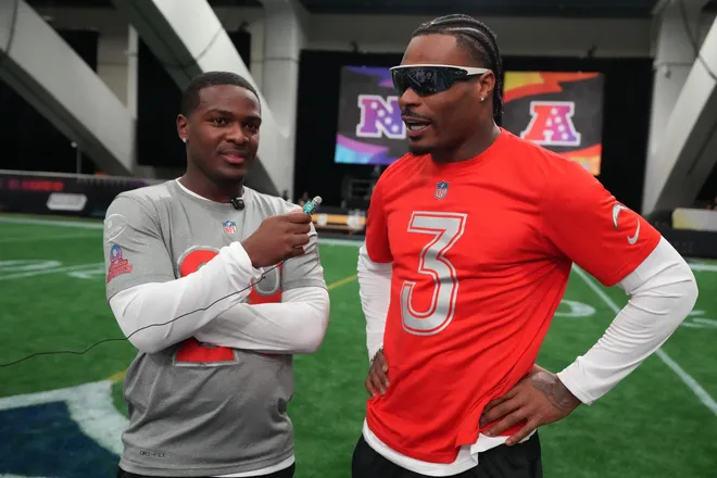 Feb 2, 2026; San Francisco, CA, USA; Miami Dolphins running back De'Von Achane (28) interviews Los Angeles Chargers safety Derwin James (3) AFC practice at the NFL Flag Fieldhouse at Moscone Center South Building. Mandatory Credit: Kirby Lee-Imagn Images