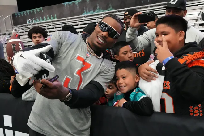 Feb 1, 2026; San Francisco, CA, USA; Los Angeles Chargers safety Derwin James (3) poses with fans during AFC practice at the Flag Fieldhouse Moscone Center South Building. Mandatory Credit: Kirby Lee-Imagn Images
