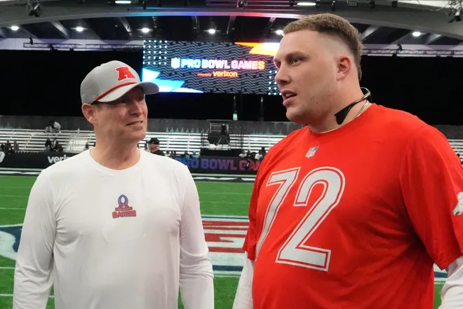 Feb 1, 2026; San Francisco, CA, USA; AFC coach Steve Young (left) talks with Denver Broncos tackle Garret Bolles (72) during practice at the Flag Fieldhouse Moscone Center South Building. Mandatory Credit: Kirby Lee-Imagn Images