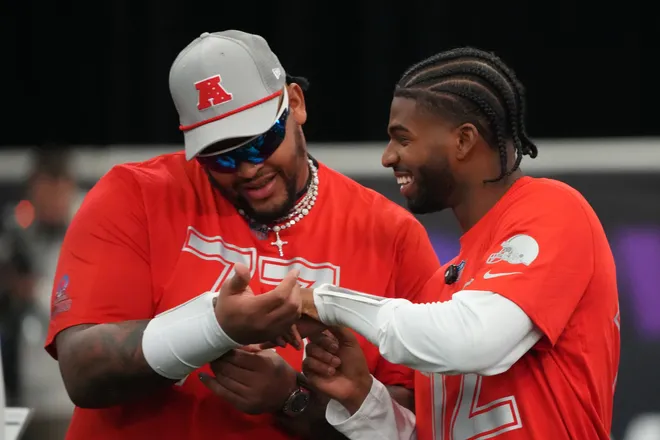 Feb 1, 2026; San Francisco, CA, USA; Buffalo Bills tackle Dion Dawkins (73) and Cleveland Browns quarterback Shadeur Sanders (12) during AFC practice at the Flag Fieldhouse Moscone Center South Building. Mandatory Credit: Kirby Lee-Imagn Images