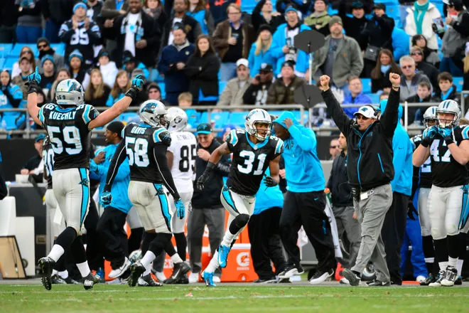Dec 22, 2012; Charlotte, NC, USA; Carolina Panthers players including linebackers Luke Kuechly (59) and Thomas Davis (58) and defensive back James Dockery (31) and head coach Ron Rivera and tight end Richie Brockel (47) react late in the game. The Panthers defeated the Raiders 17-6 at Bank of America Stadium. Mandatory Credit: Bob Donnan-USA TODAY Sports