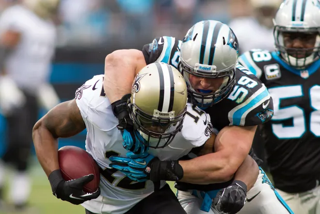 Dec 22, 2013; Charlotte, NC, USA; New Orleans Saints wide receiver Marques Colston (12) is tackled by Carolina Panthers middle linebacker Luke Kuechly (59) after catching a pass during the second quarter at Bank of America Stadium. Mandatory Credit: Jeremy Brevard-USA TODAY Sports