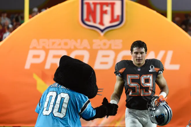Jan 25, 2015; Phoenix, AZ, USA; Team Irvin linebacker Luke Kuechly of the Carolina Panthers (59) shakes hands with Panthers mascot Sir Purr in the 2015 Pro Bowl against Team Carter at University of Phoenix Stadium. Mandatory Credit: Kyle Terada-USA TODAY Sports