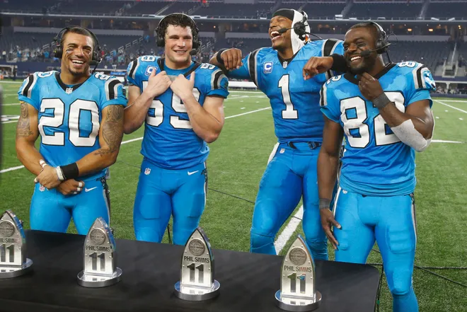 Nov 26, 2015; Arlington, TX, USA; Carolina Panthers free safety Kurt Coleman (20) and middle linebacker Luke Kuechly (59) and quarterback Cam Newton (1) and wide receiver Jerricho Cotchery (82) accept the Phil Simms All Iron award after the game against the Dallas Cowboys on Thanksgiving at AT&T Stadium. Carolina won 33-14. Mandatory Credit: Tim Heitman-USA TODAY Sports