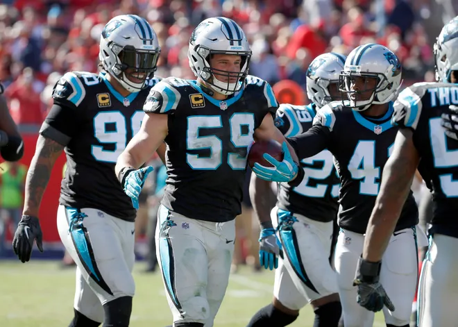 Oct 29, 2017; Tampa, FL, USA; Carolina Panthers middle linebacker Luke Kuechly (59) is congratulated as he intercepted the ball from Tampa Bay Buccaneers tight end Cameron Brate (84) (not pictured) during the second half at Raymond James Stadium. Mandatory Credit: Kim Klement-USA TODAY Sports