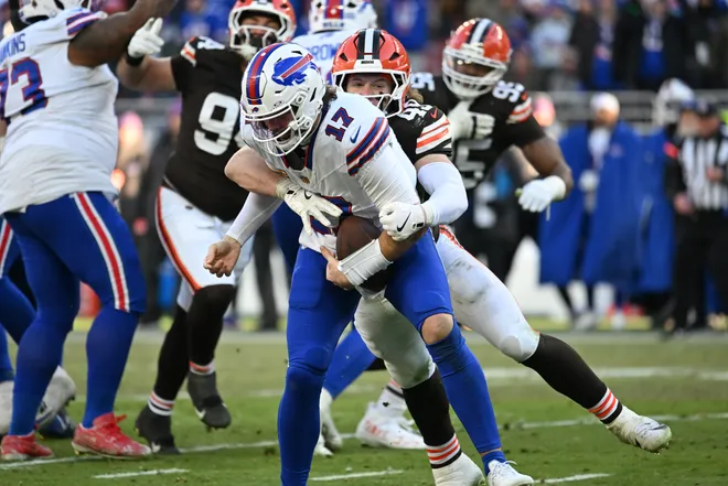 Dec 21, 2025; Cleveland, Ohio, USA; Buffalo Bills quarterback Josh Allen (17) is sacked by Cleveland Browns linebacker Carson Schwesinger (49) during the second half at Huntington Bank Field. Mandatory Credit: Ken Blaze-Imagn Images