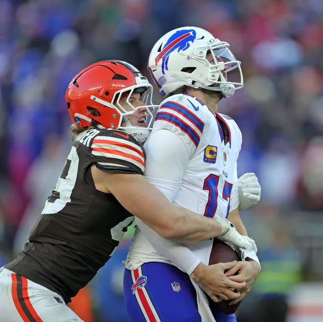 Cleveland Browns linebacker Carson Schwesinger (49) sacks Buffalo Bills quarterback Josh Allen (17) during the second half of an NFL football game at Huntington Bank Field, Dec. 21, 2025, in Cleveland, Ohio.