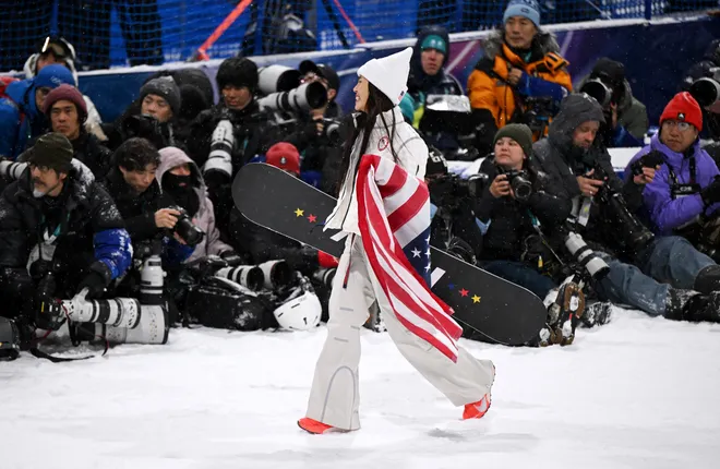 Silver medalist Chloe Kim of Team United States celebrates in front of a group of photographers.