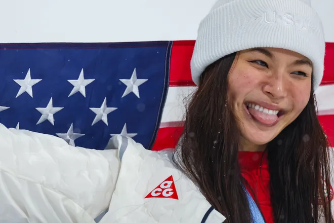 Silver medalist Chloe Kim of Team United States celebrates with the national flag of the United States.
