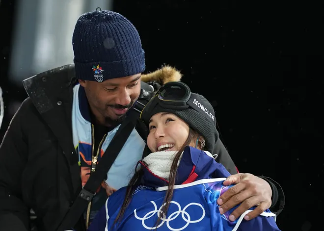 Chloe Kim of the United States with Cleveland Browns player Myles Garrett after her second run.